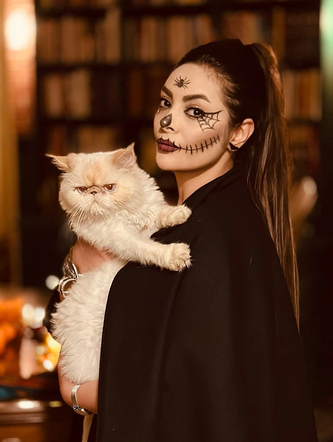 Black cat Halloween costume with cat ears, whiskers, and black outfit