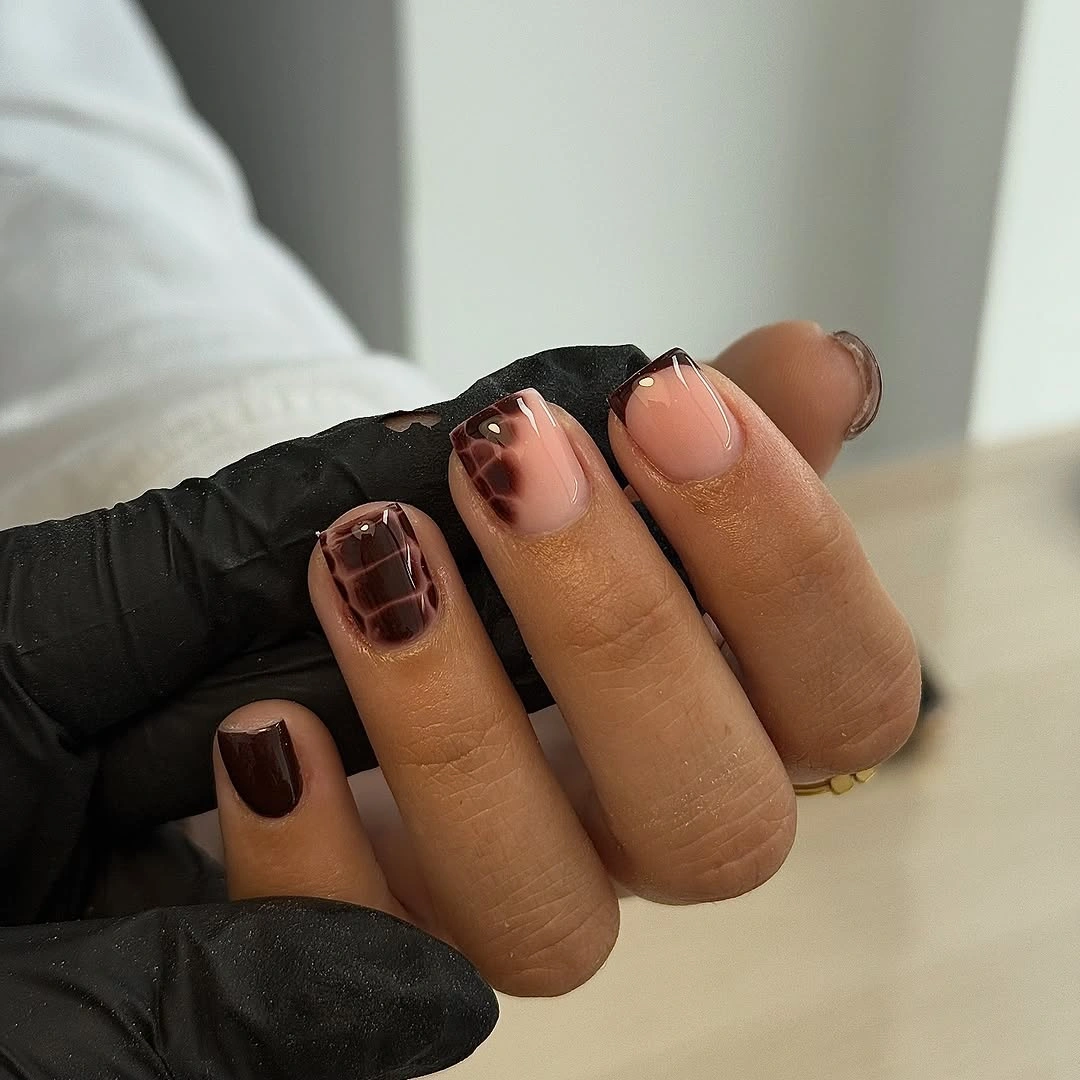 Long almond nails with burgundy brown and nude mixed details