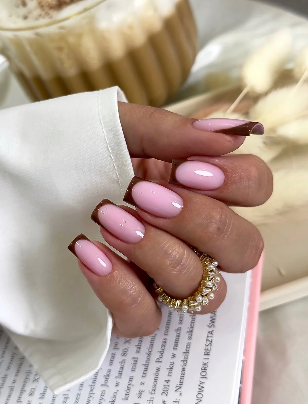 Long chocolate almond nails with small bright accent details