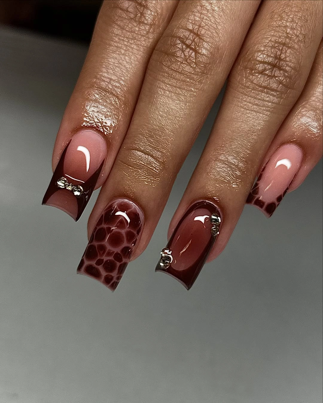 Long almond nails mixing chestnut solids nude space and brown accents
