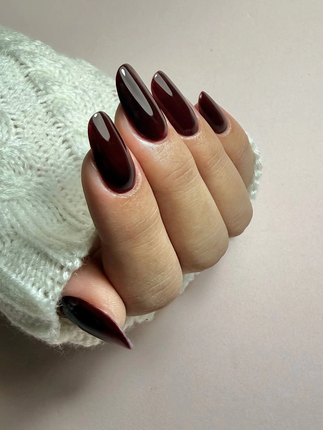Long almond nails in deep glossy burgundy brown