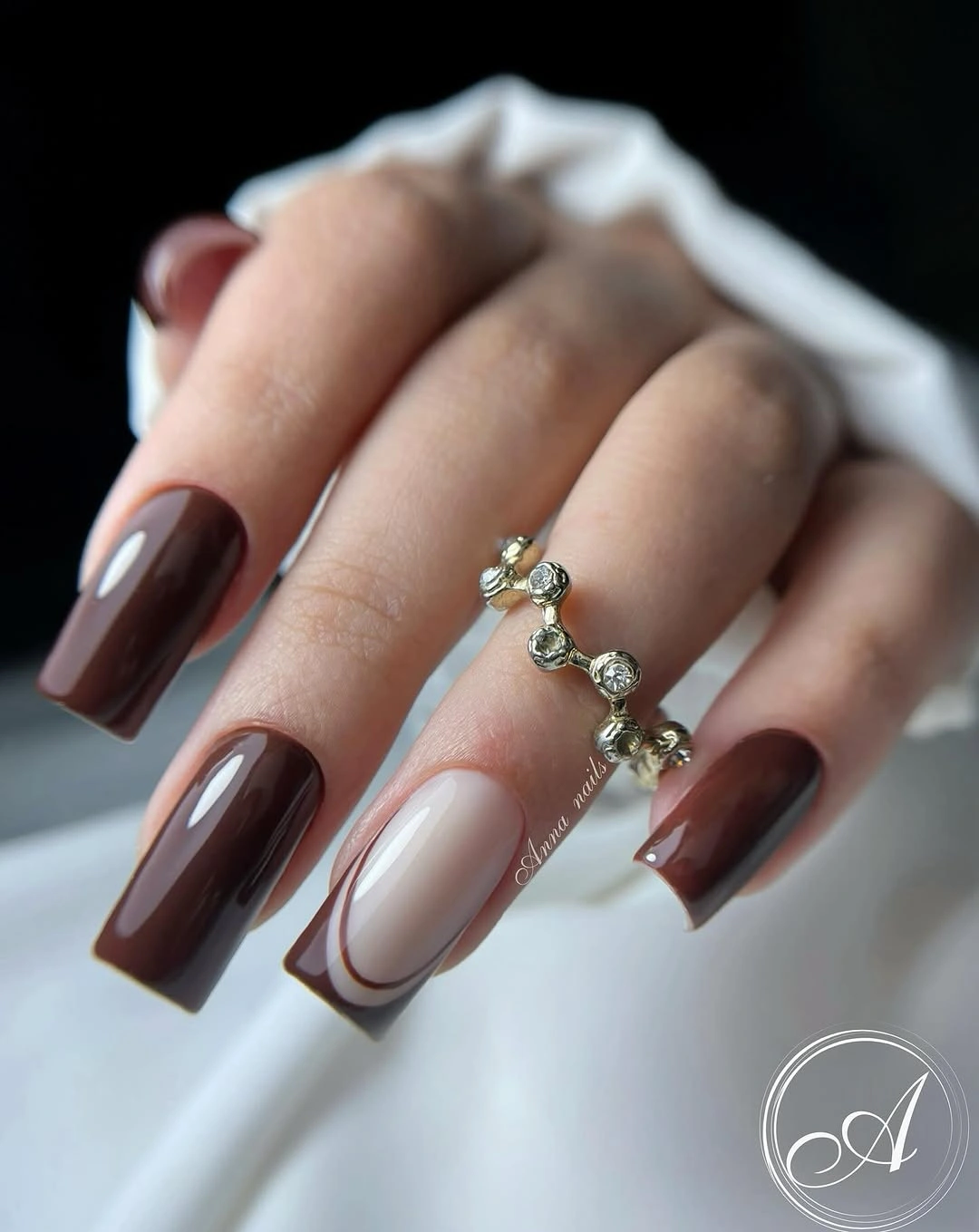 Long square chocolate nails with one pale outlined accent