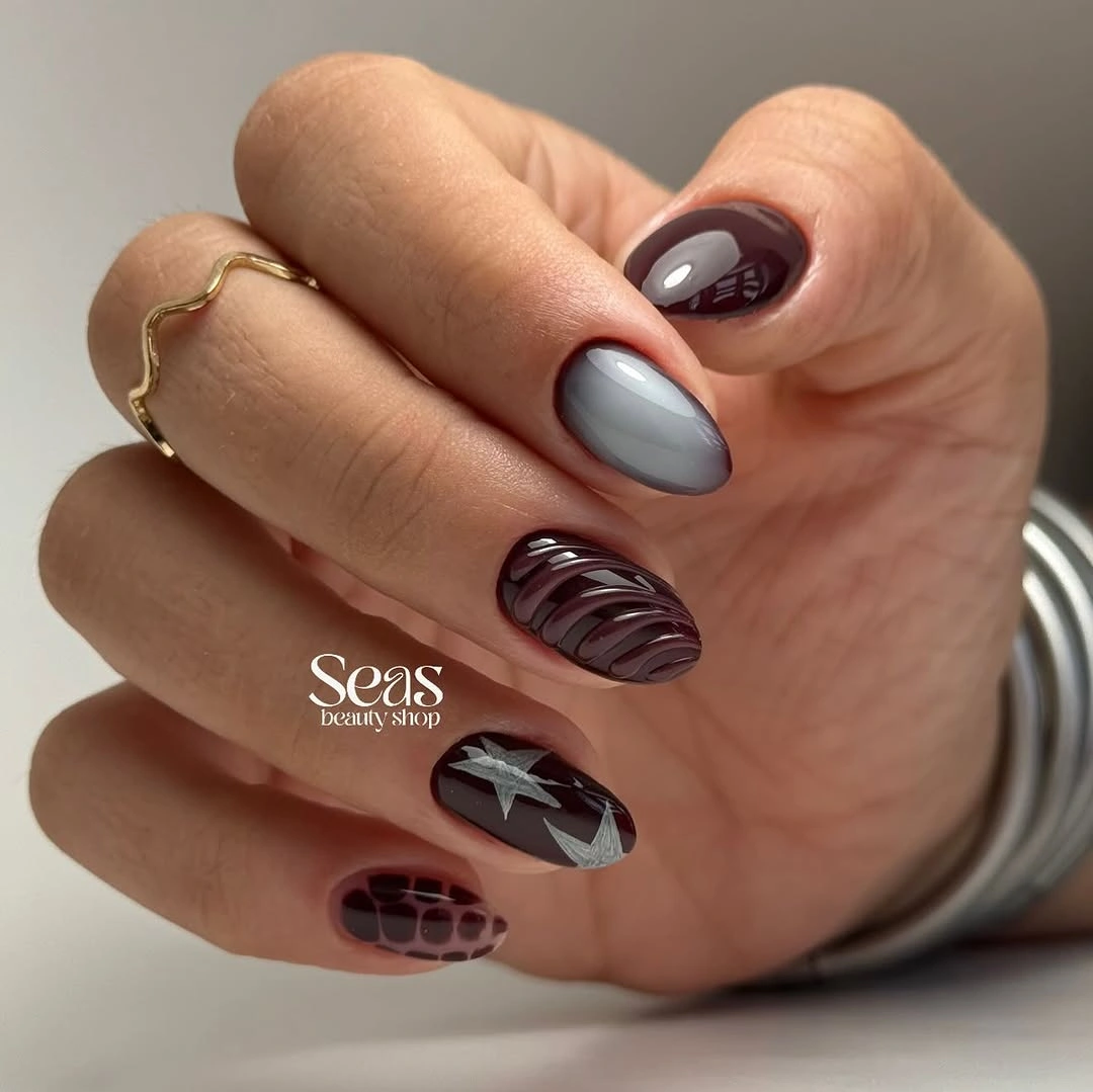 Short dark nails with plum, silver, stripes, and a star accent