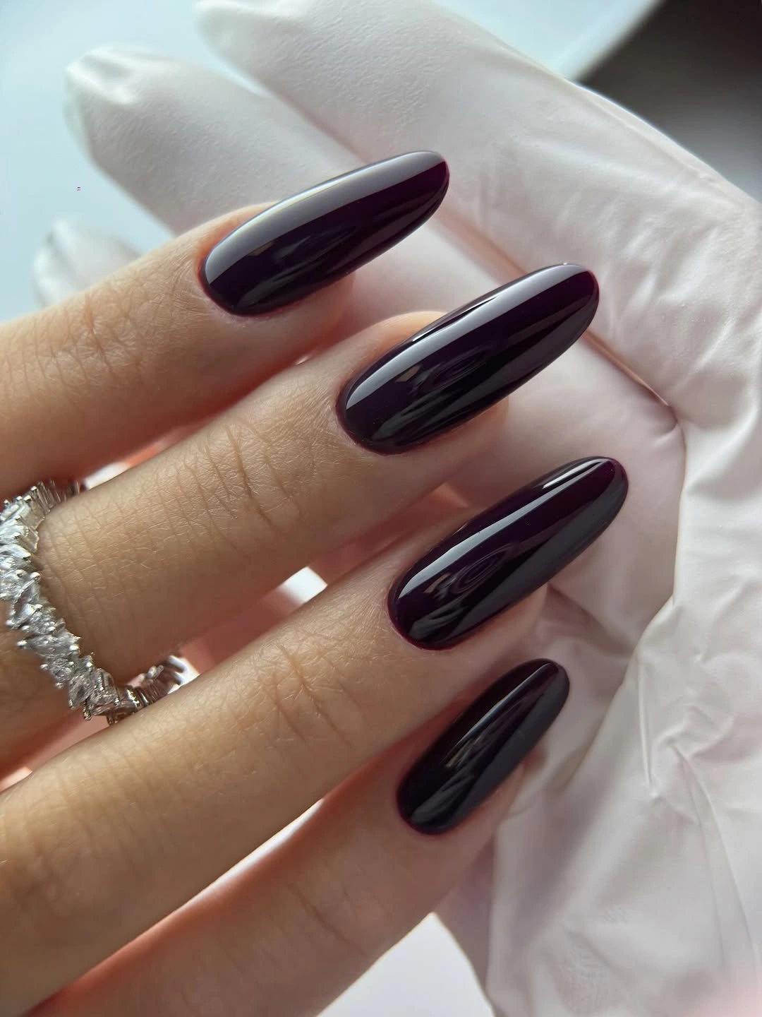 Long glossy almost-black plum almond nails