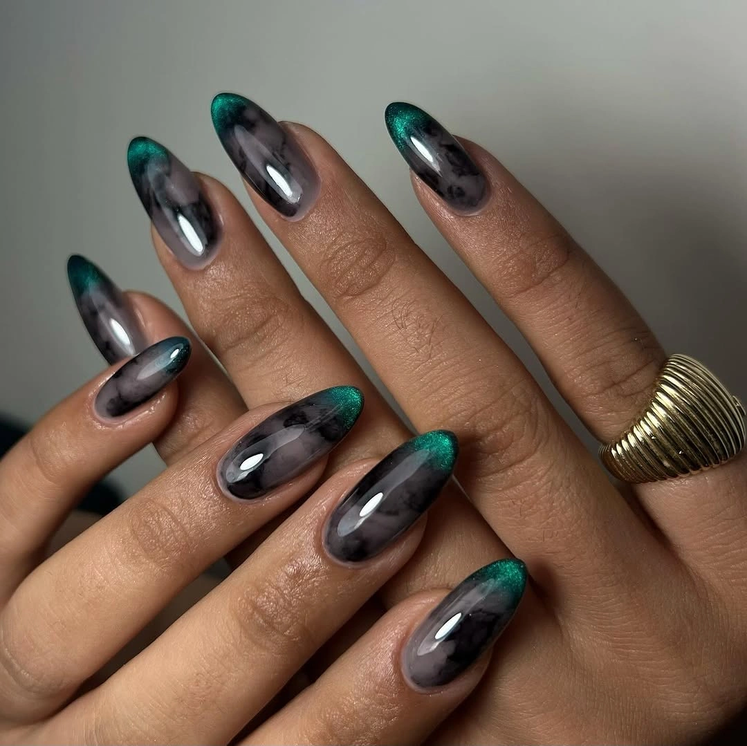 Long smoky black almond nails with emerald reflective patches