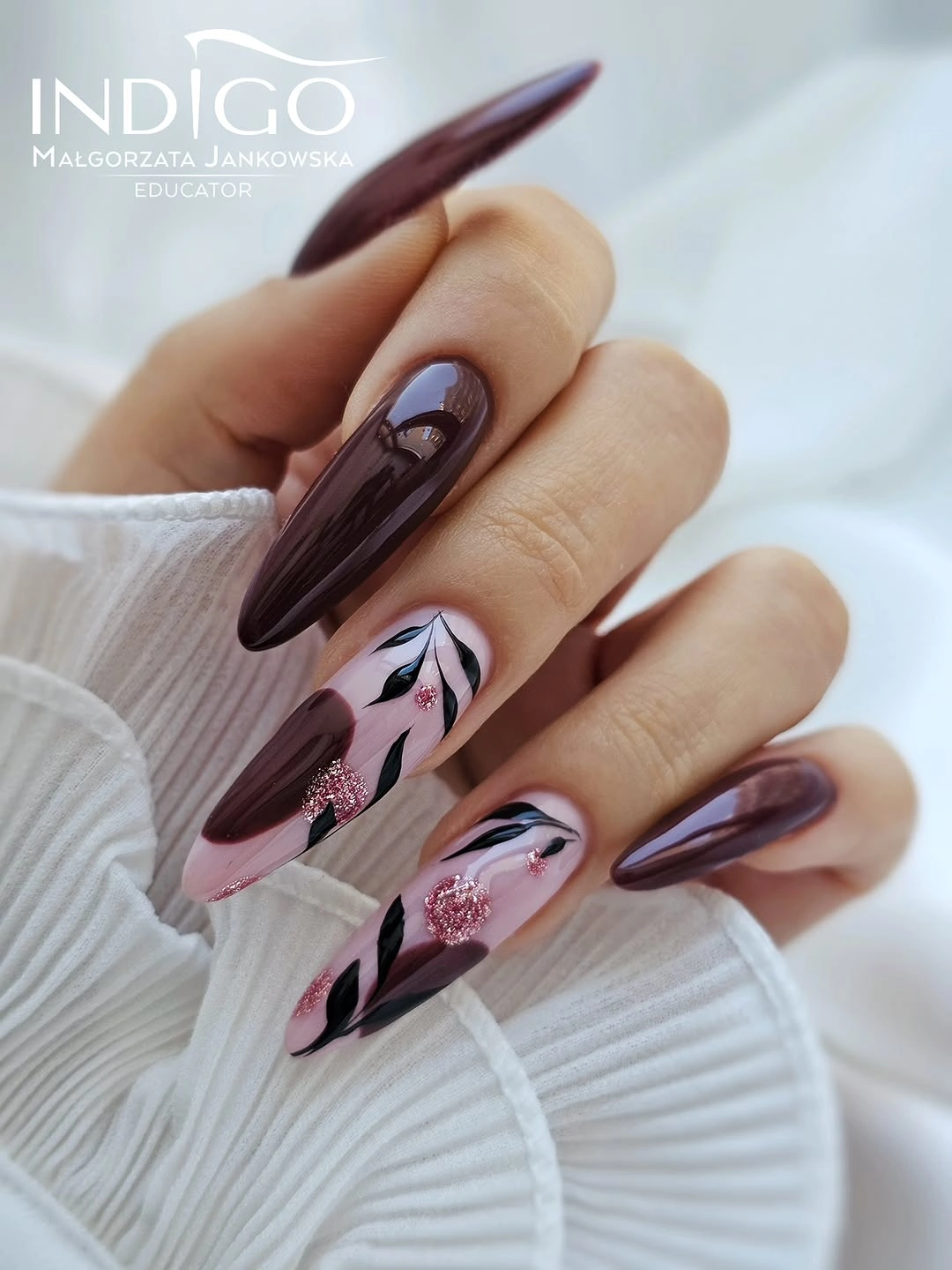 Long plum almond nails with pale pink leaf accents
