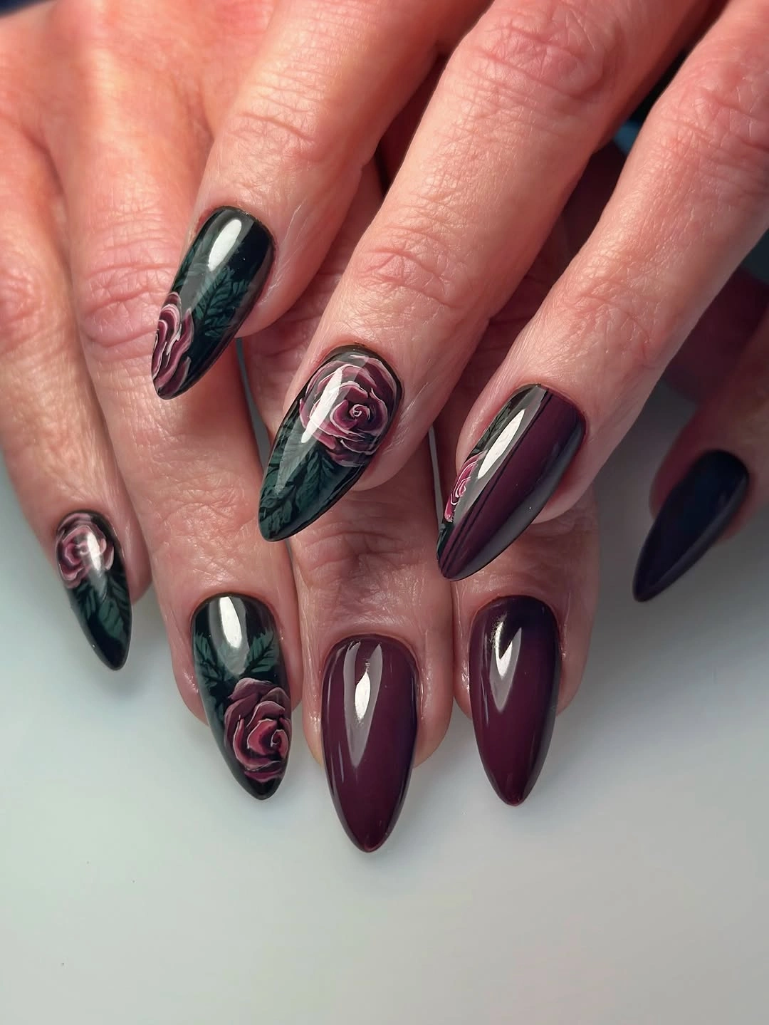 Long wine and black pointed nails with rose illustrations