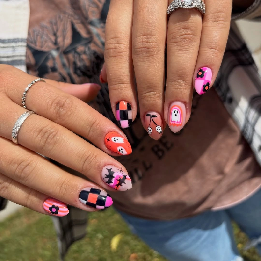Playful short nails with coral, pink, lilac, and graphic motifs