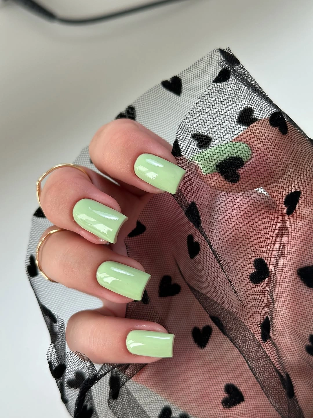 Short glossy square nails in pale lime green