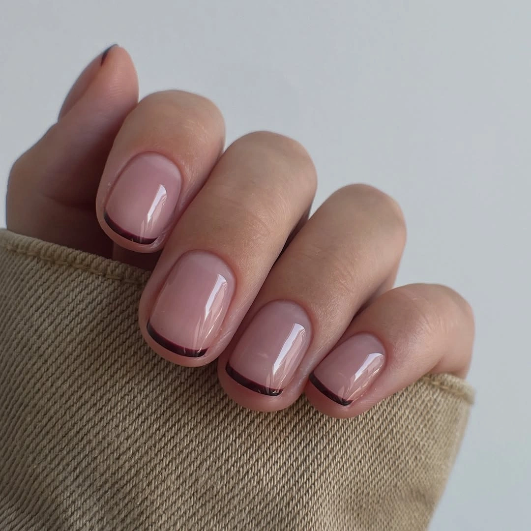 Short sheer pink square nails with thin burgundy tips