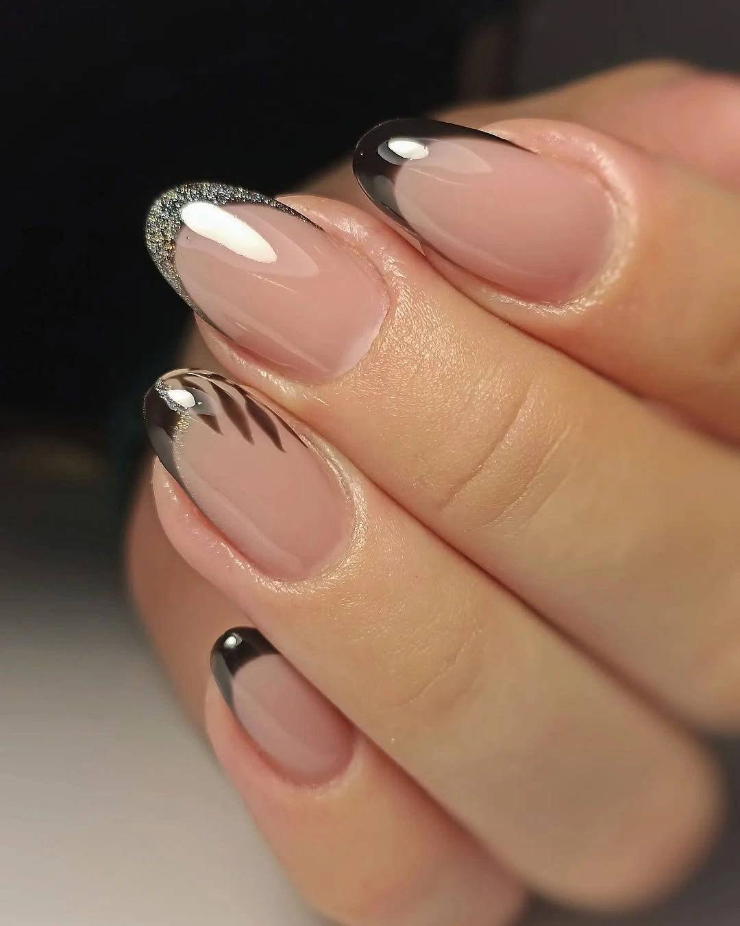 Short sheer pink nails with black and silver micro French edges