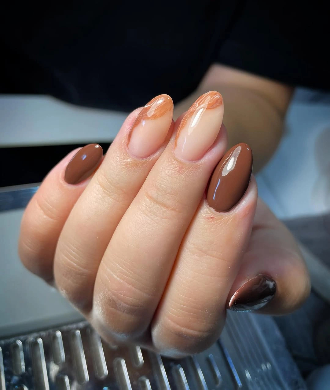 Medium almond nails with chocolate brown solids and warm accents