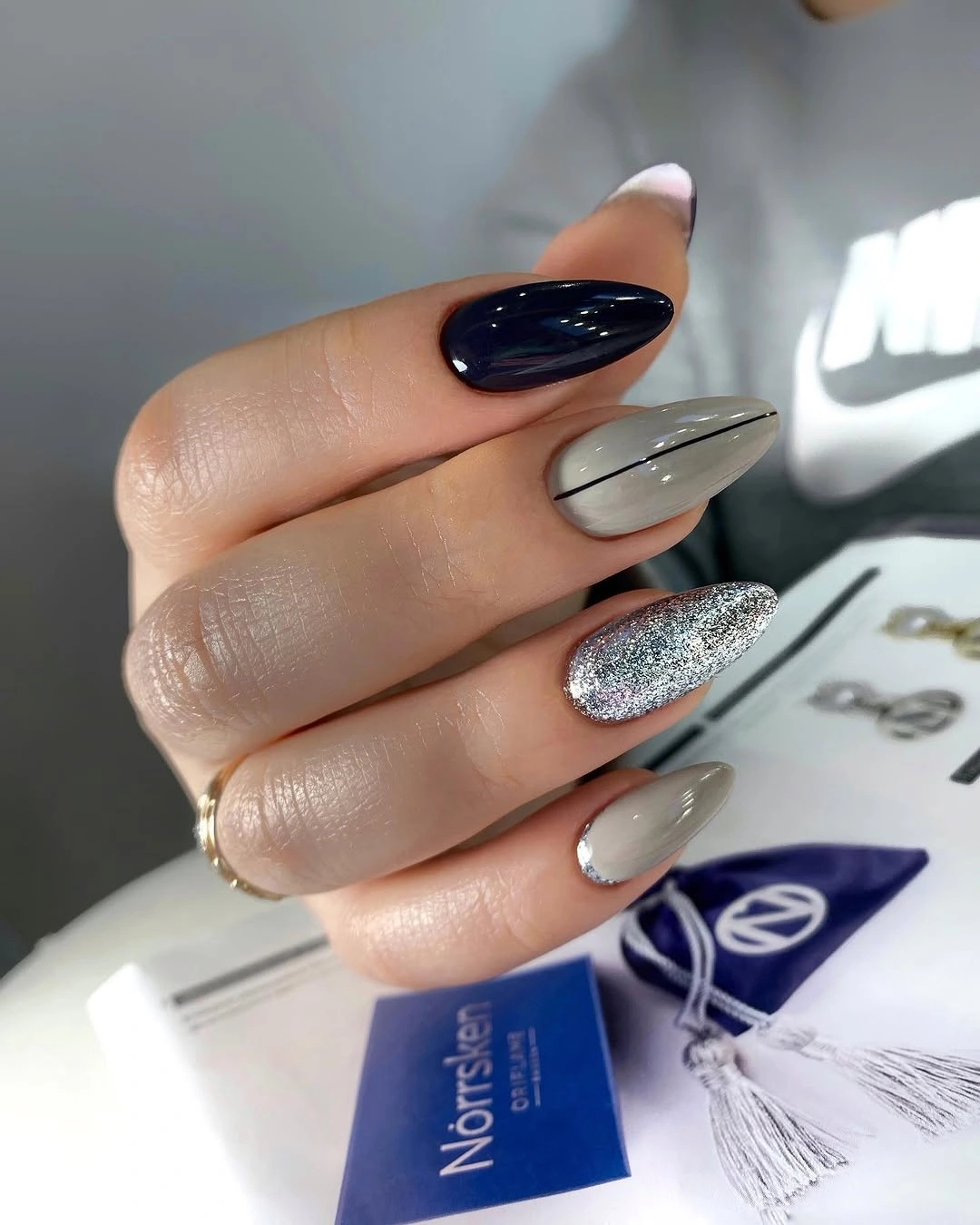 Long almond nails mixing black silver grey and glitter accents