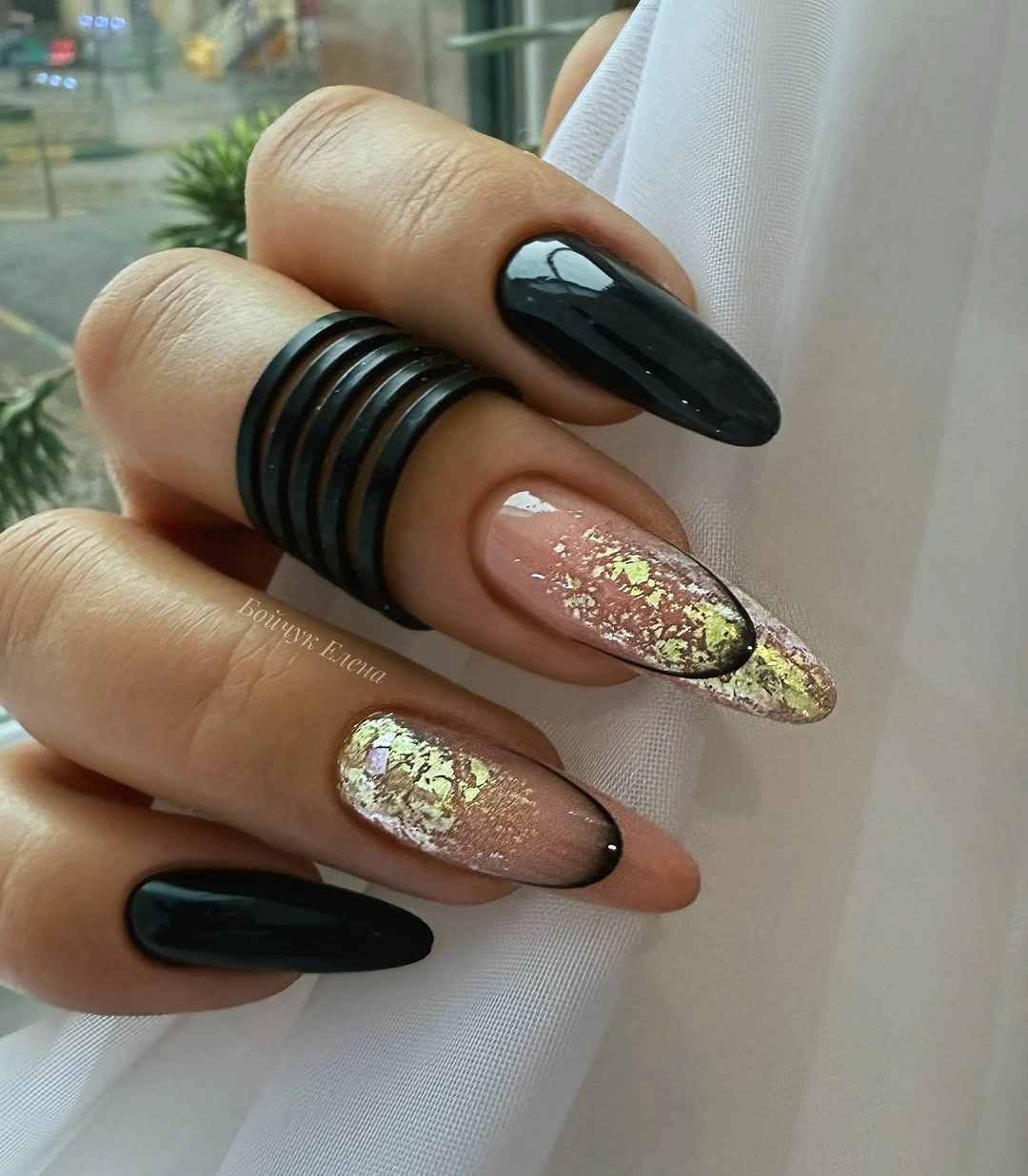 Long almond nails with black solids and pale glitter brown accents