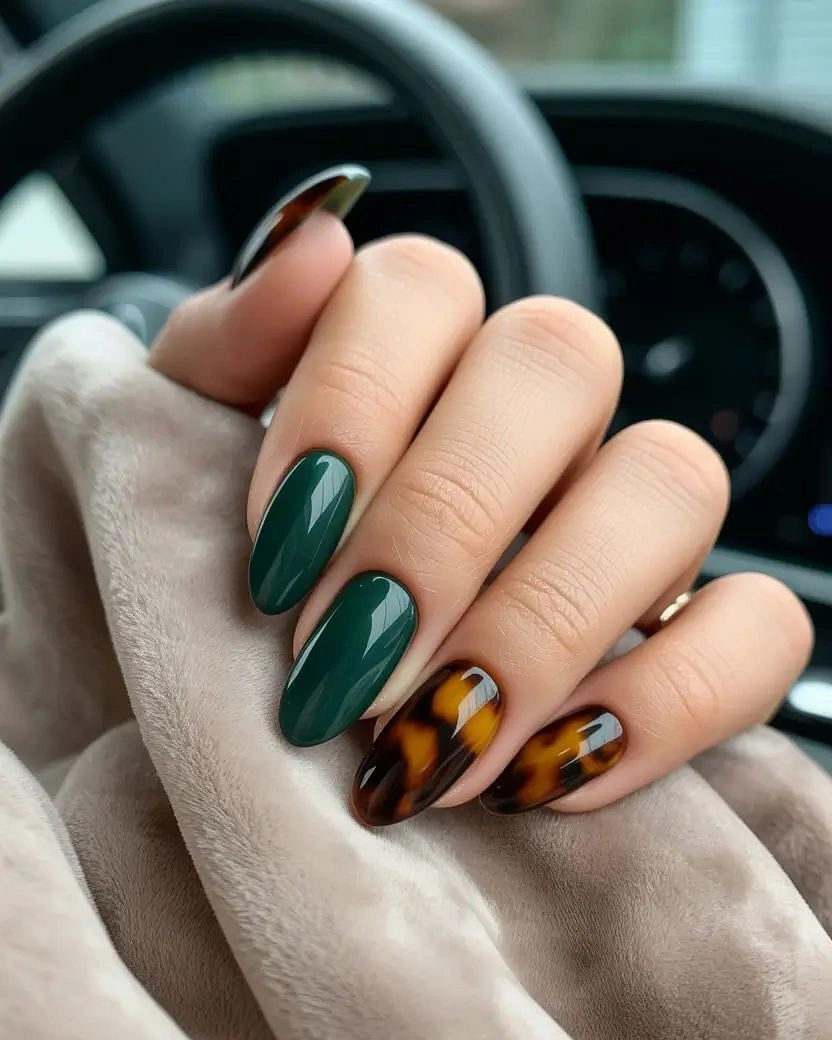 Deep green almond nails with amber brown accent nails