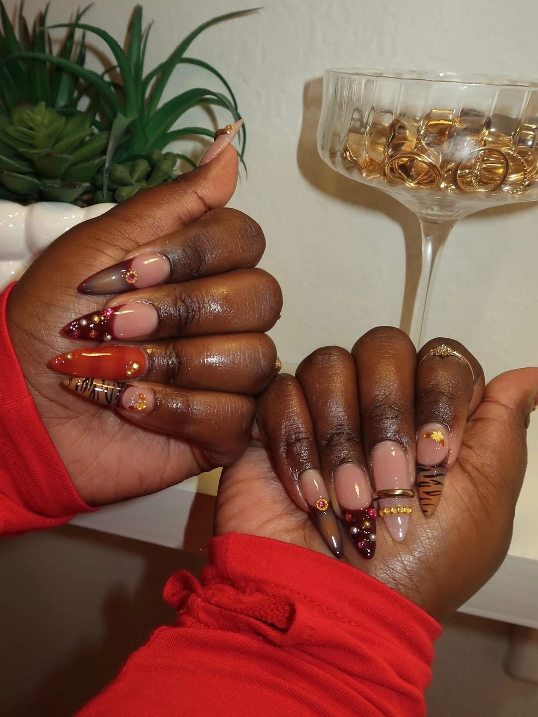 Mixed nails with red brown amber patterned panels and gold details