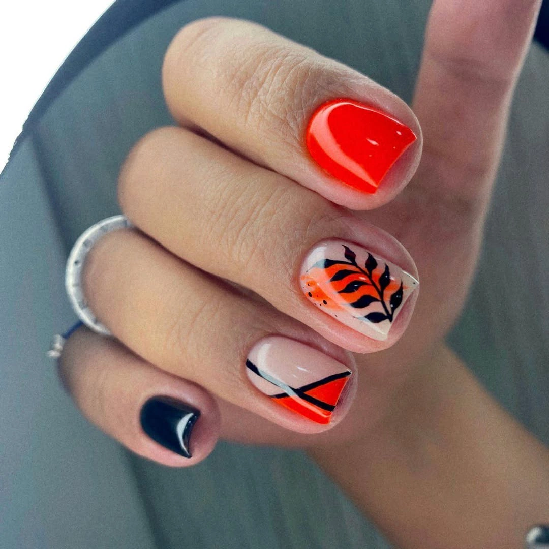 Short square nails with red black white and orange striped accents