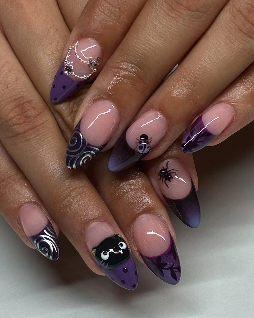 Purple Halloween almond nails with bats and webs