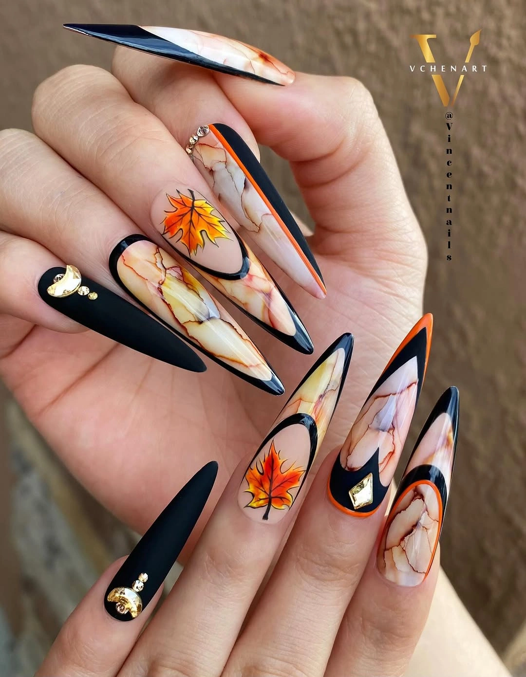 Long black stiletto nails with orange autumn flowers