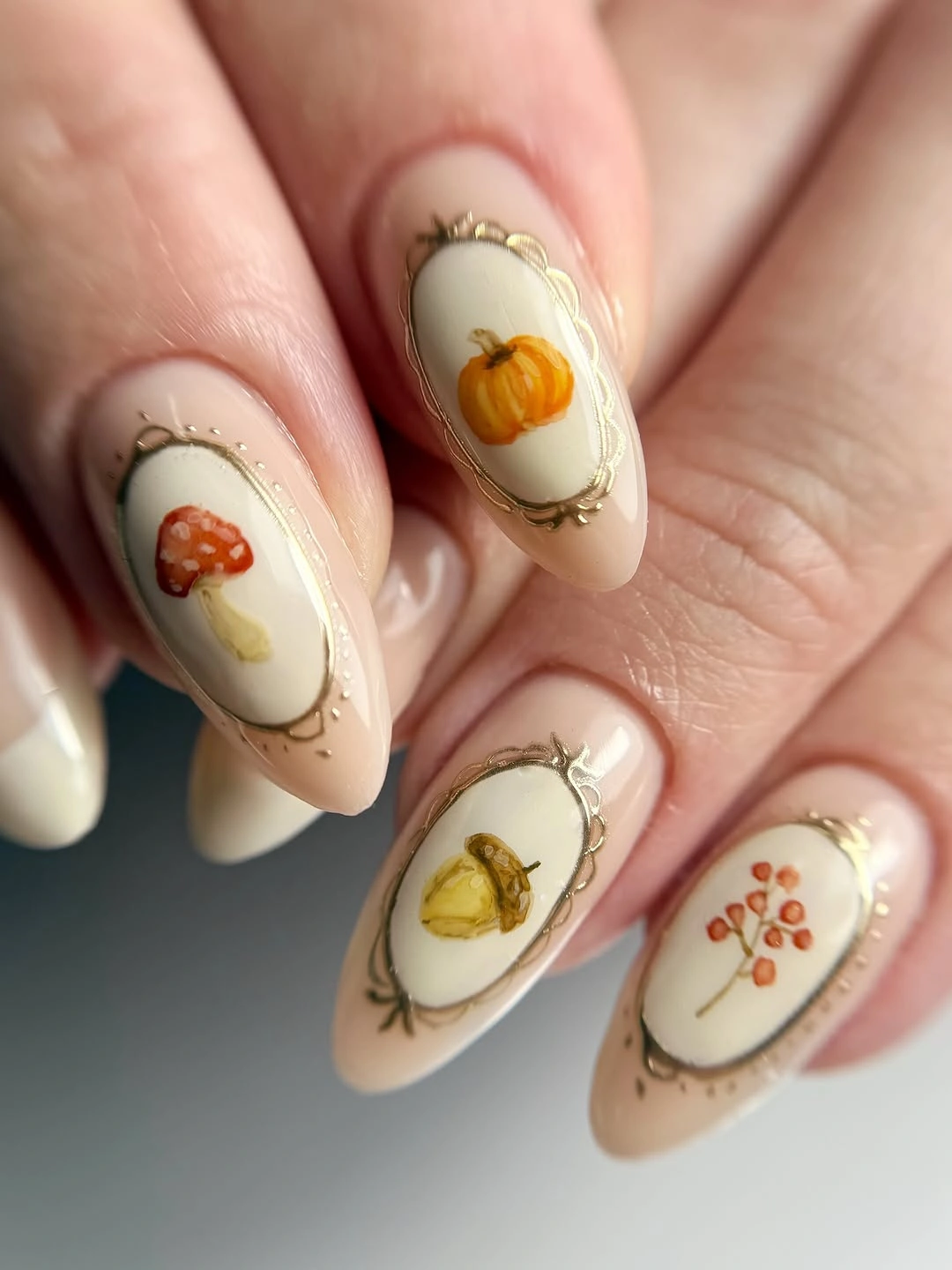 Cream almond nails with pumpkins pears and berries