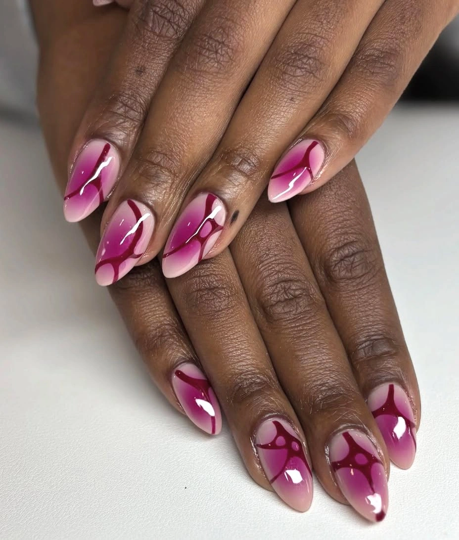Pink almond nails with burgundy swoop french tips