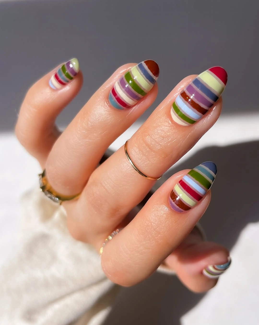 Short striped nails in colorful fall tones
