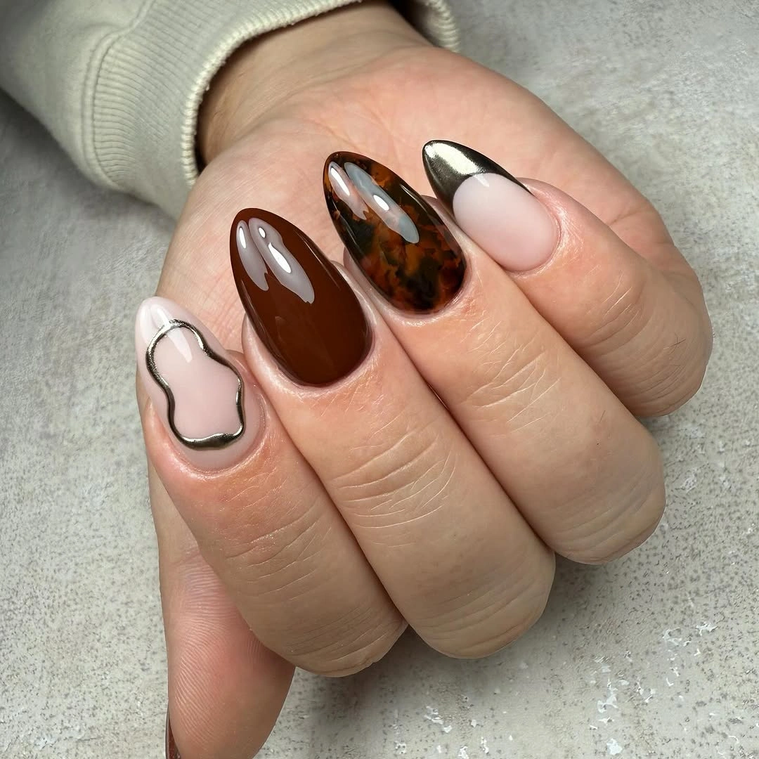 brown tortoise almond nails with chrome and abstract accents
