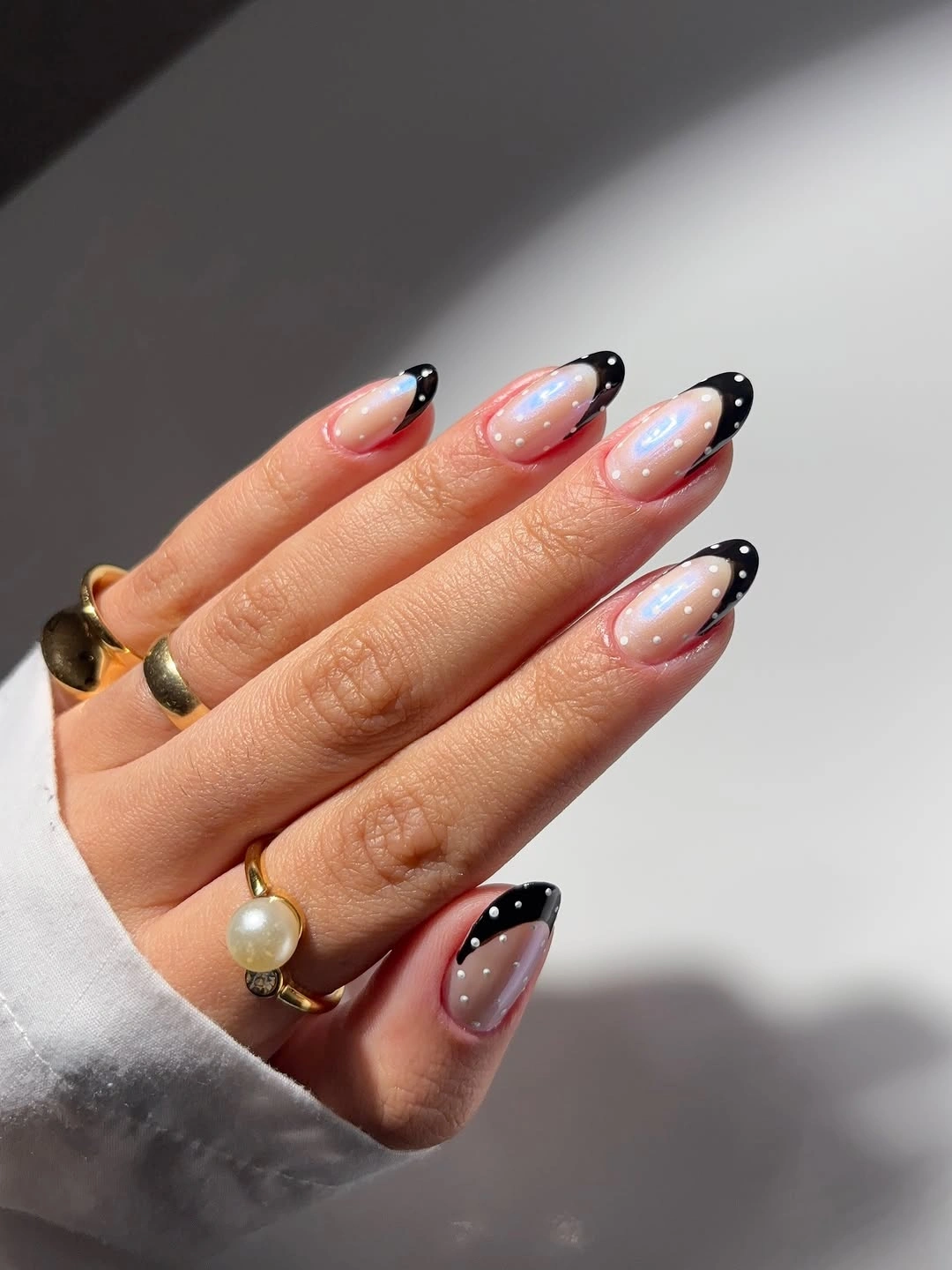 pearl almond nails with black dotted French tips