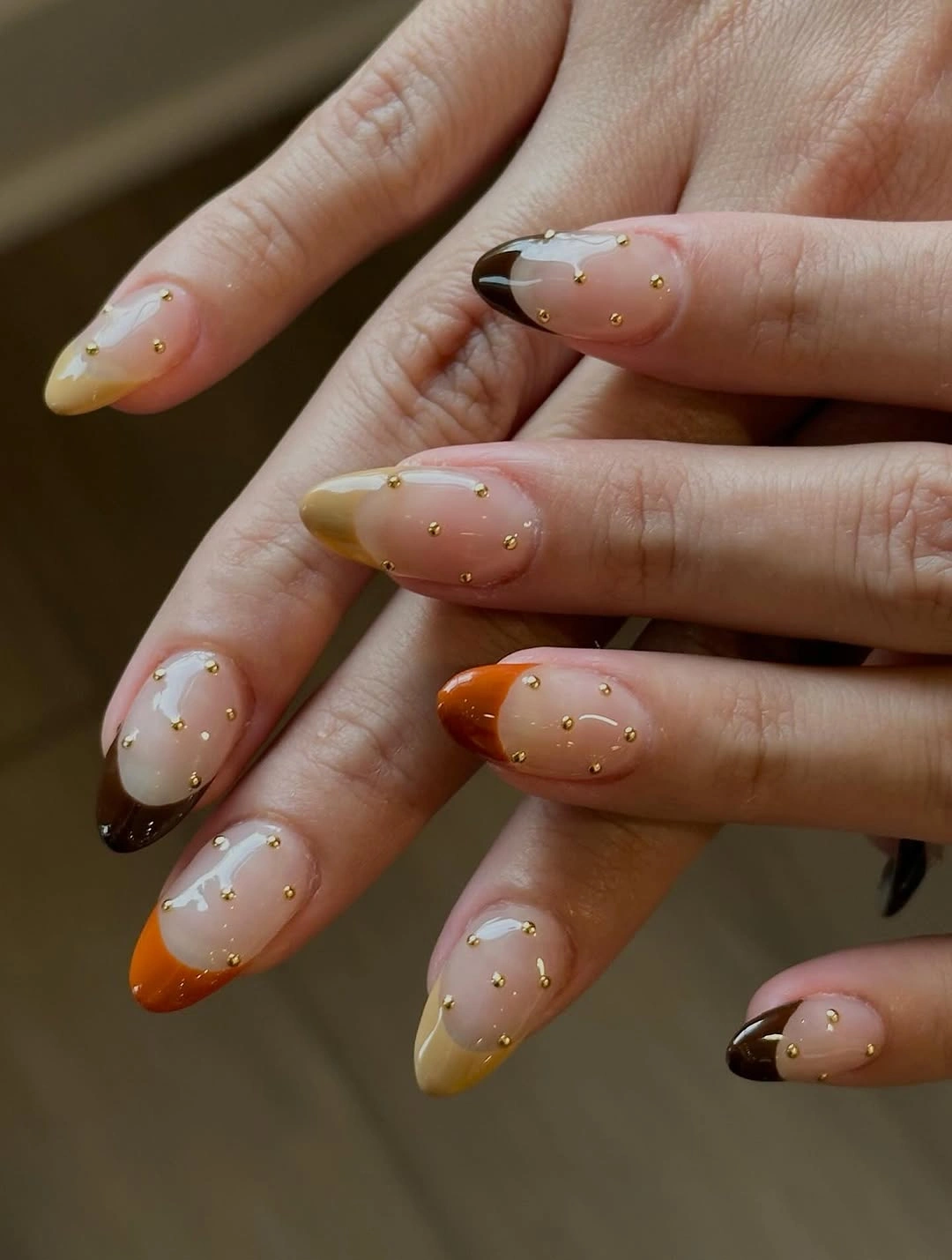 fall almond nails with warm French tips and gold studs