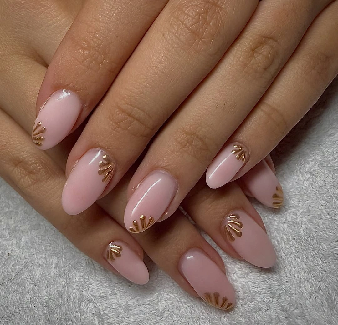 soft pink almond nails with gold fan accents