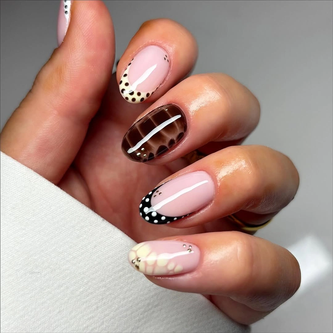 short almond nails with tortoise dots and mixed accents