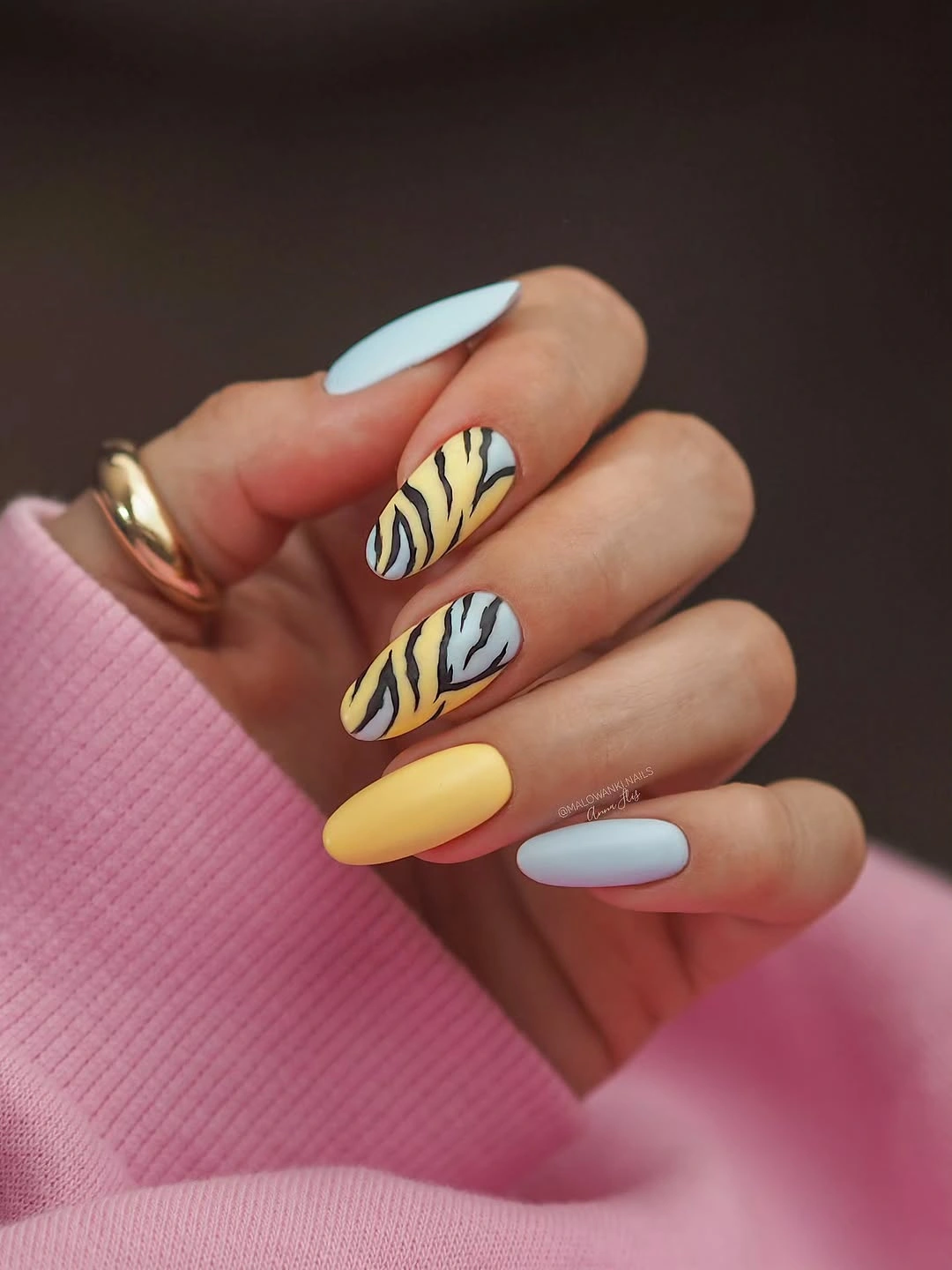 pastel almond nails with yellow tiger stripe accents