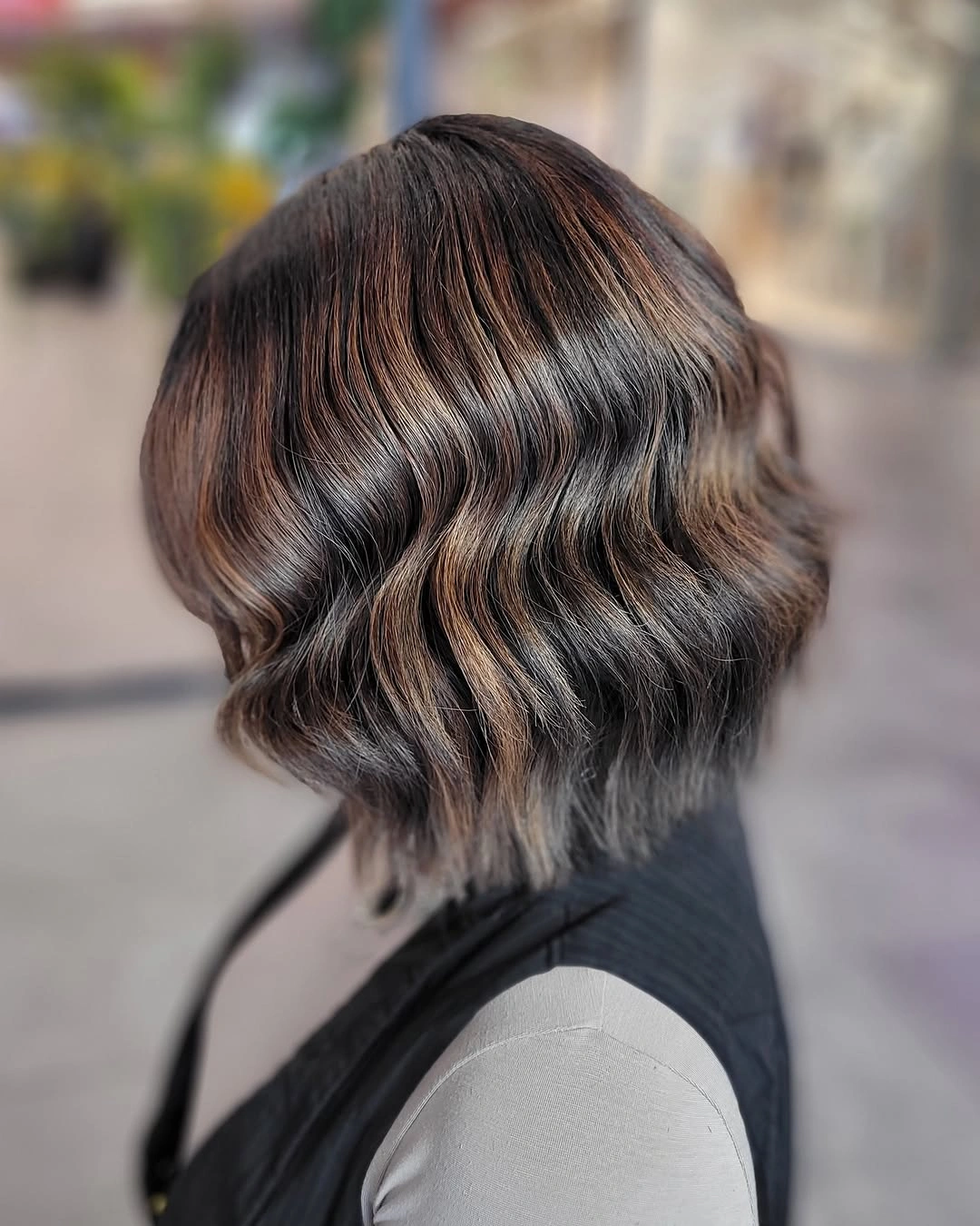 Short textured brunette bob with one warm side reflection