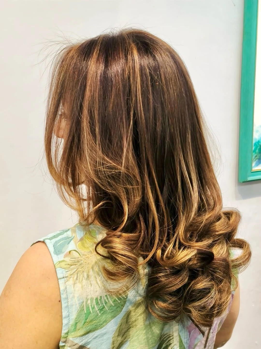 Gathered medium brown hair with warm golden curled ends