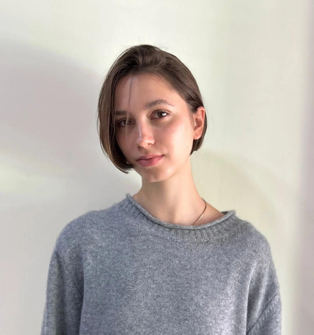 Short sleek espresso brown bob with a clean side part
