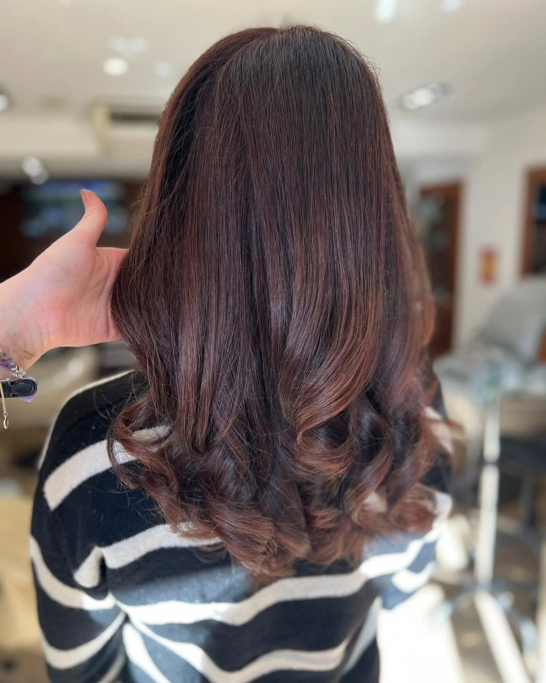 Long chestnut waves with muted auburn dimension through the ends