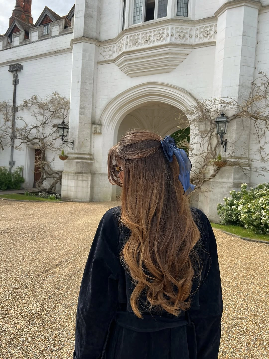 Half-up brown waves with warm caramel variation through the lengths
