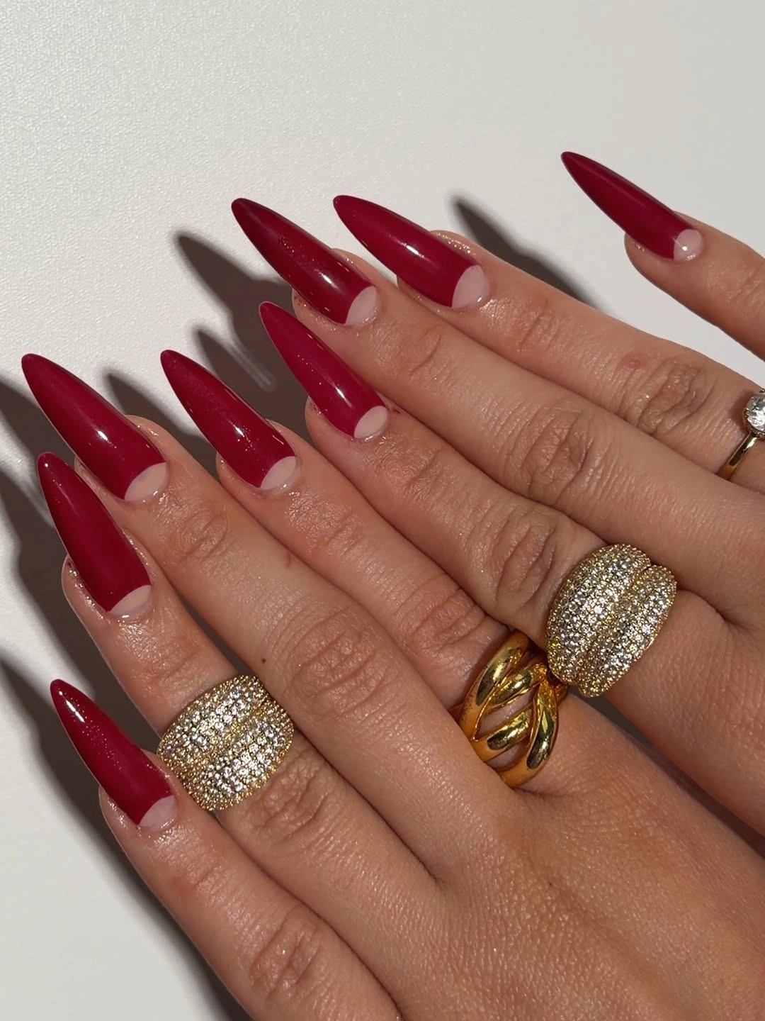 Long pointed burgundy nails with glossy solid color