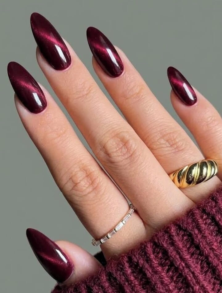 Long almond burgundy chrome nails with reflective highlights