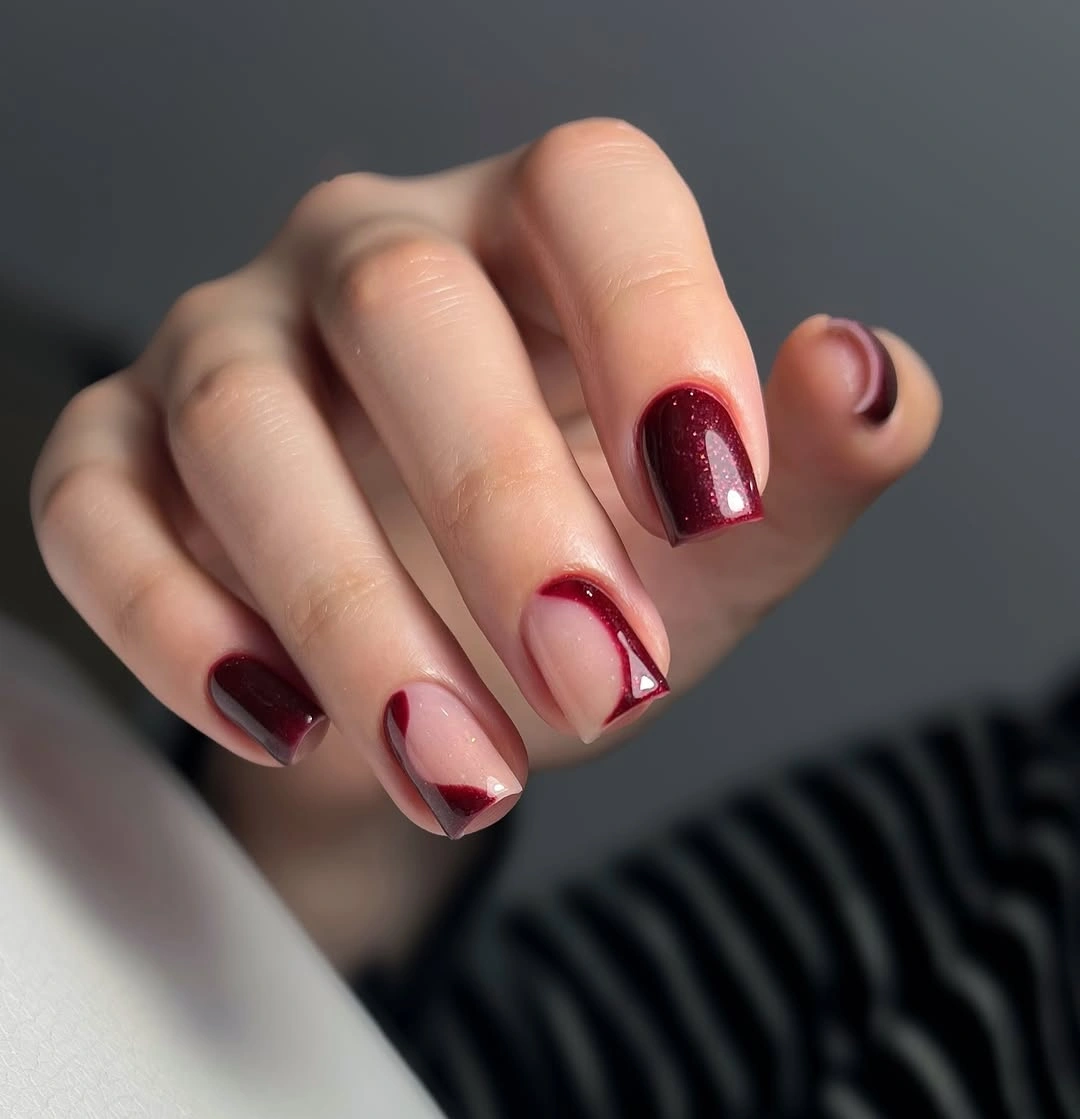 Short square burgundy nails with nude negative-space borders