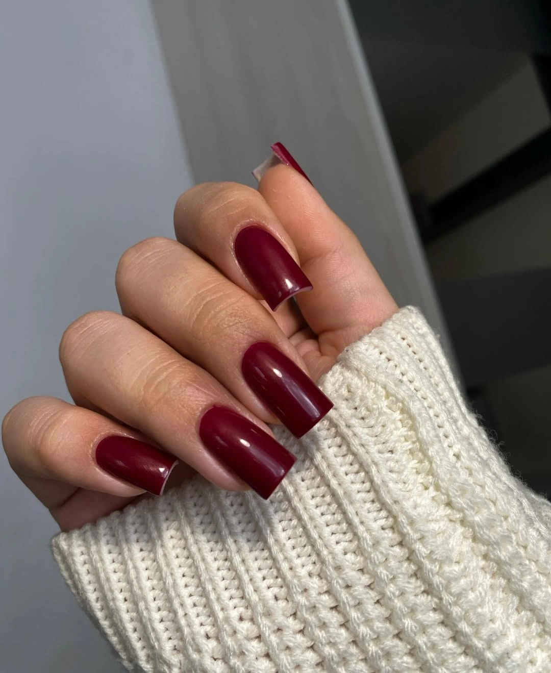 Long square glossy burgundy nails with cream knit texture