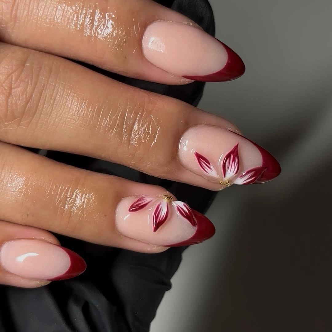 Long almond burgundy French tips with floral accents
