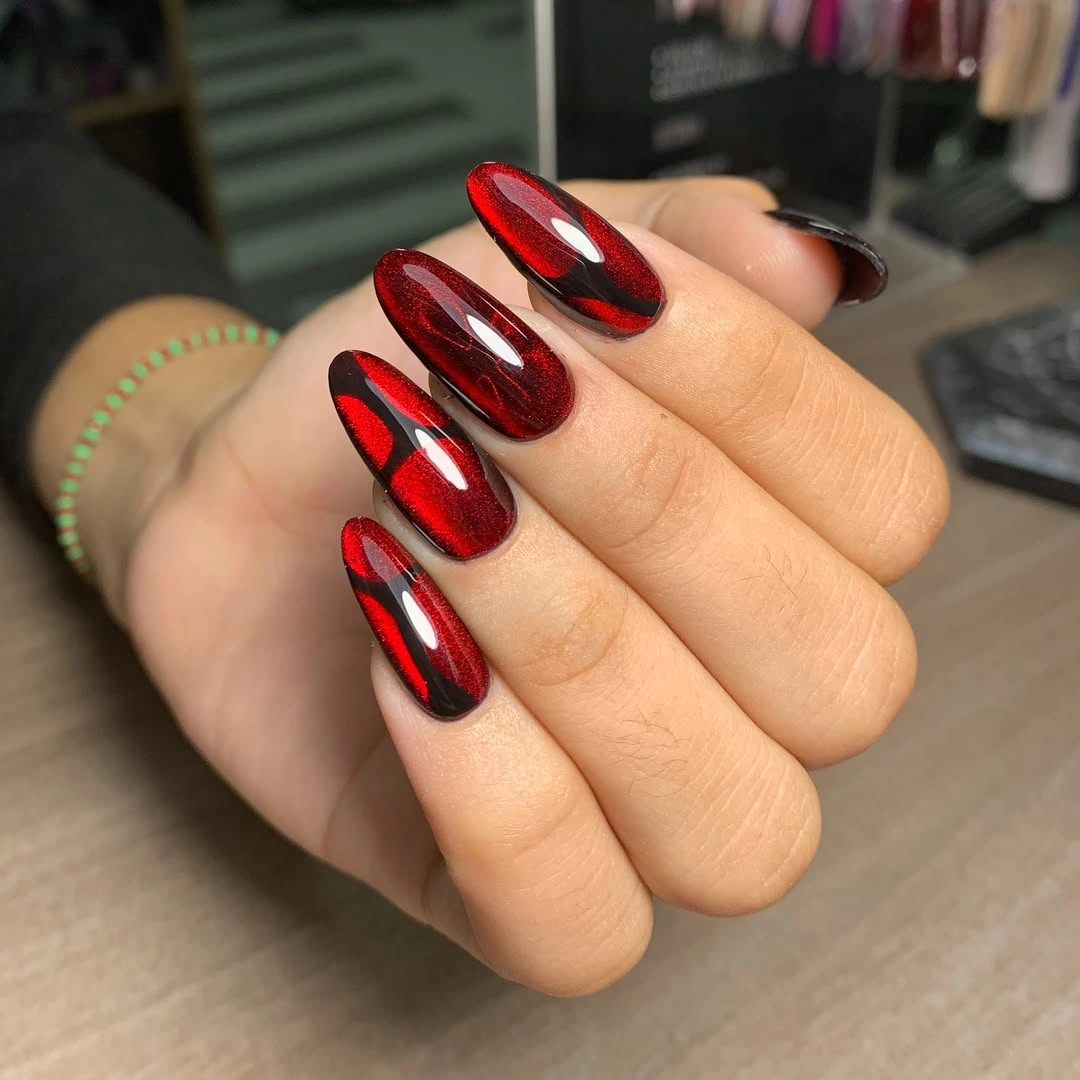 Medium almond nails with reflective metallic red burgundy finish