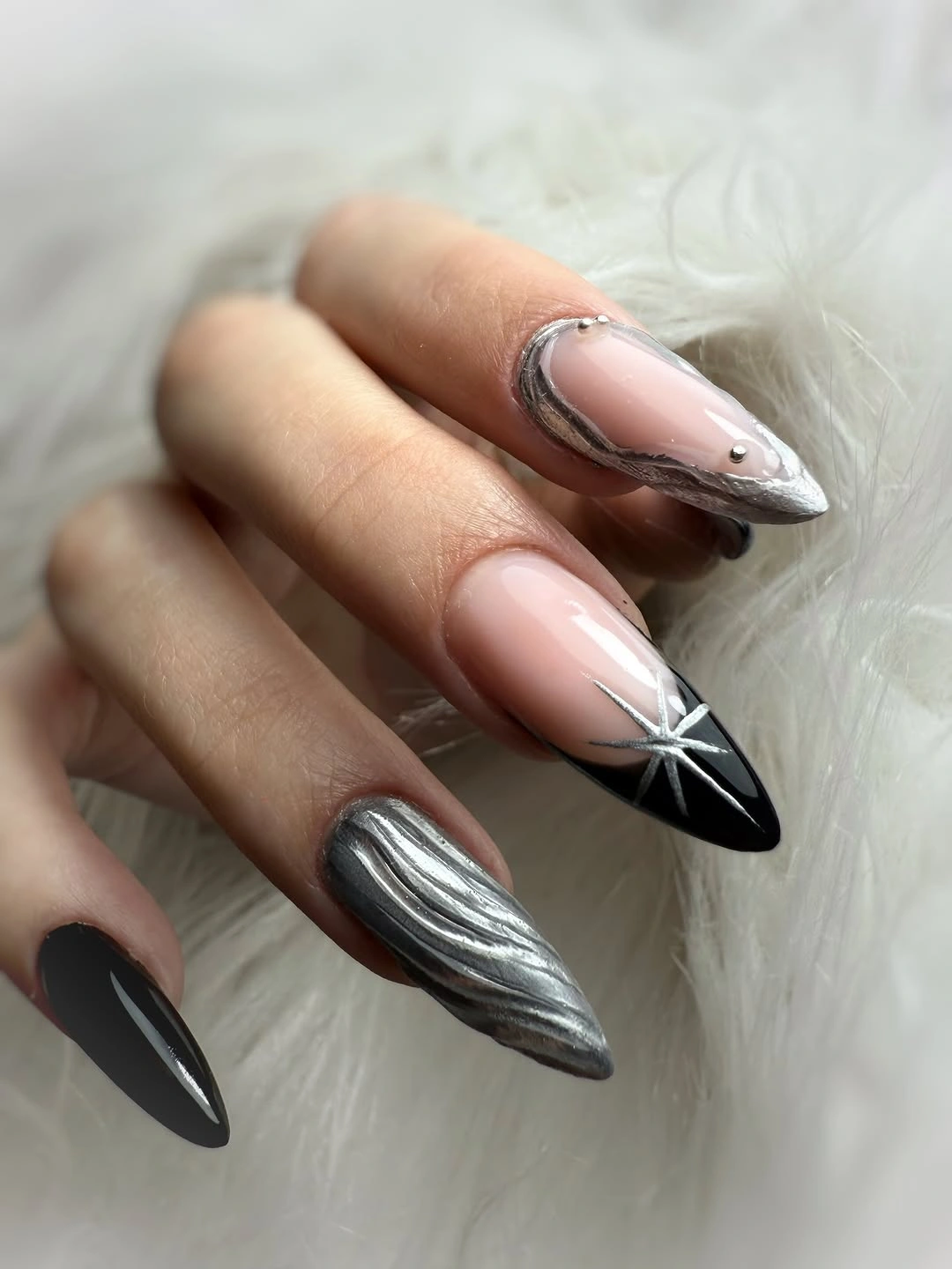 Long almond pale nails with silver edge and black point