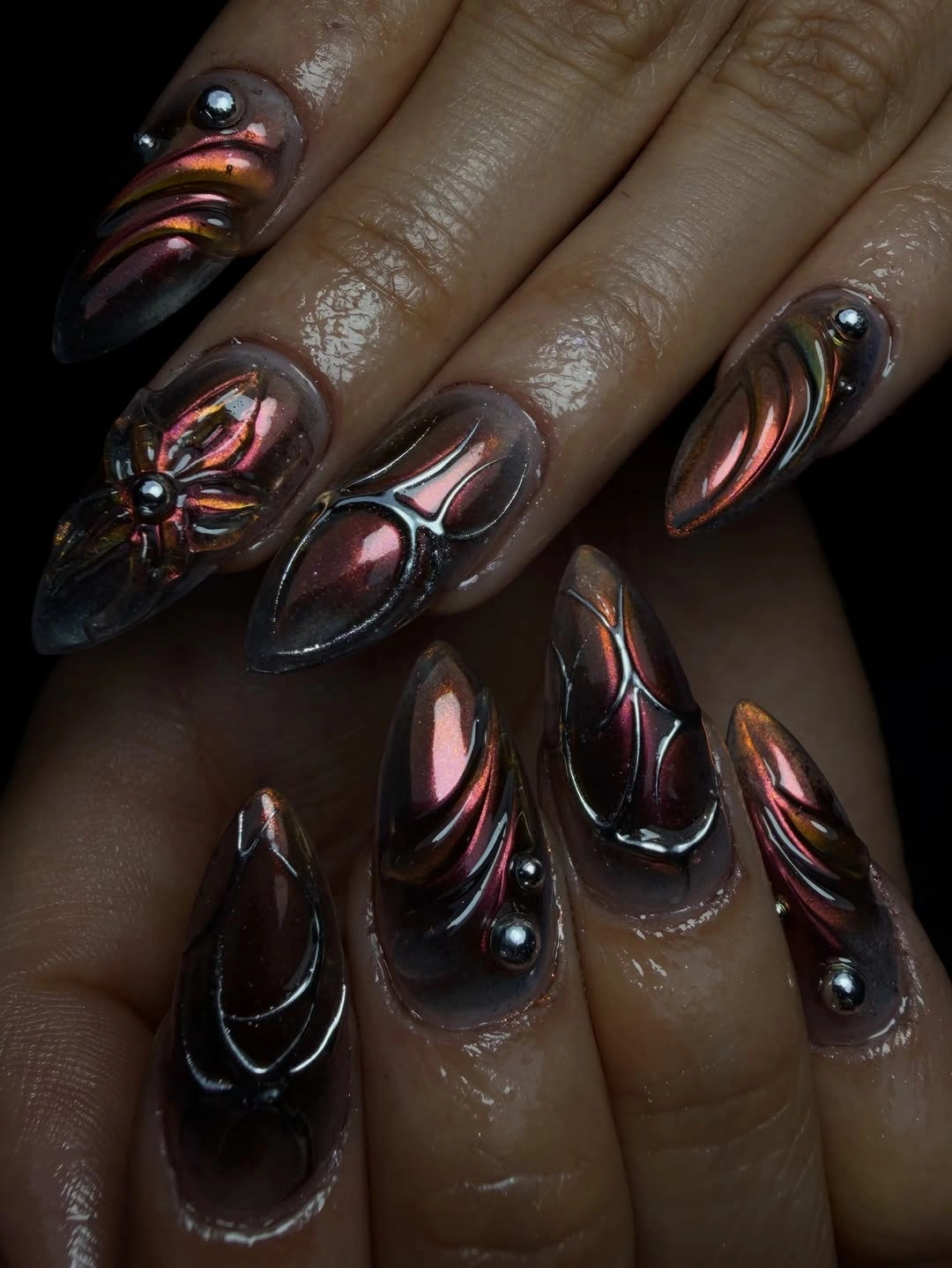 Long stiletto dark nails with reflective curved accents