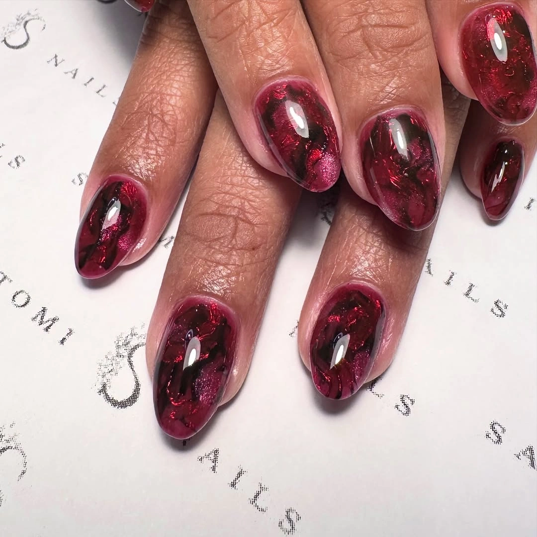 Medium almond burgundy nails with glossy berry reflections