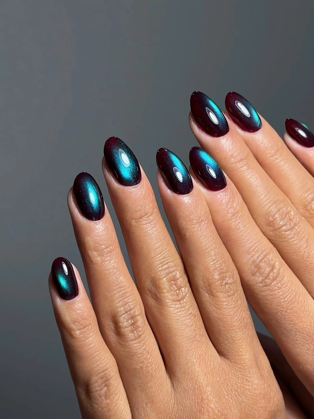 Medium almond nails with deep blue and violet reflections