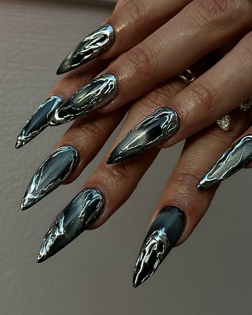 Long pointed charcoal nails with silver contour lines