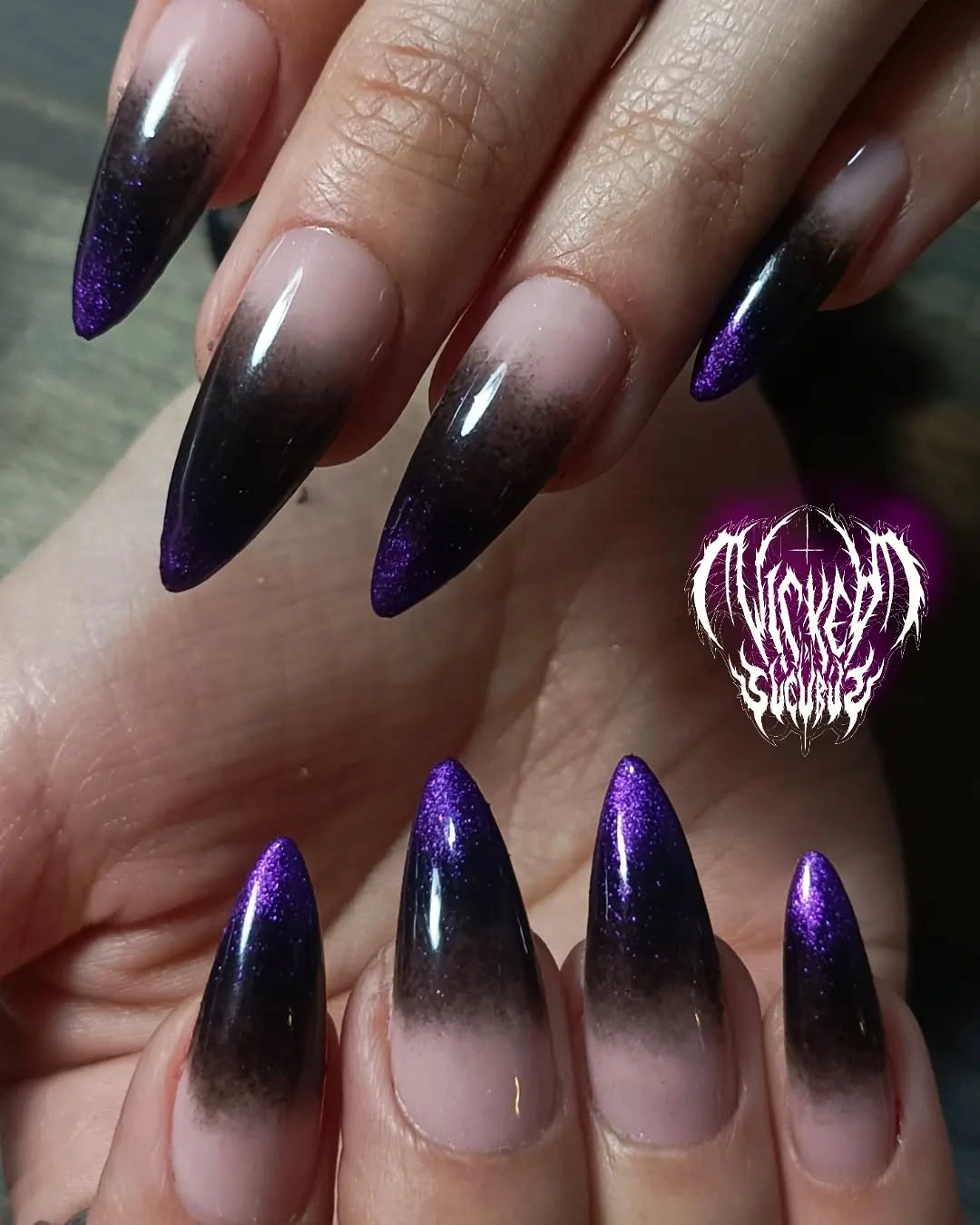 Medium almond nails fading from sheer nude to deep plum