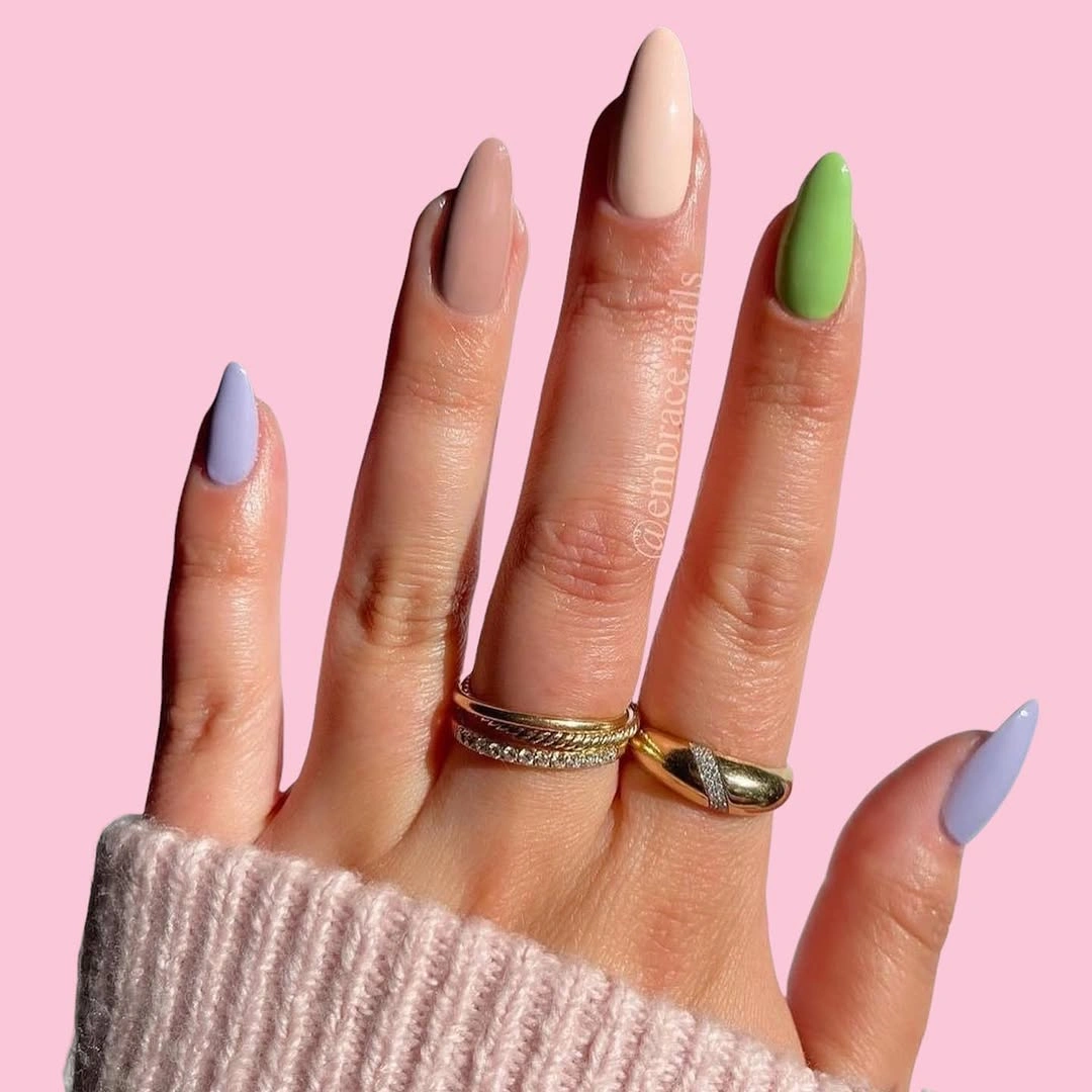 Long almond nails in muted pink pale blue lime green warm brown and creamy nude